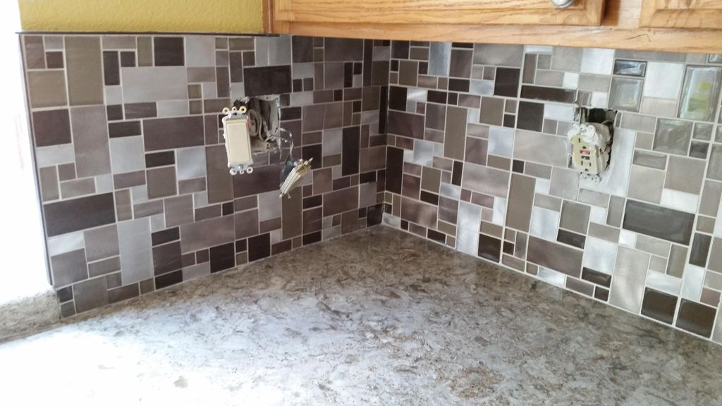 Glass and aluminum backsplash installation.