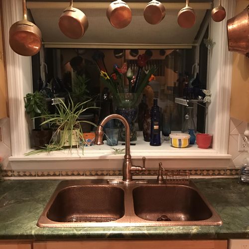 A new copper faucet and sink installed