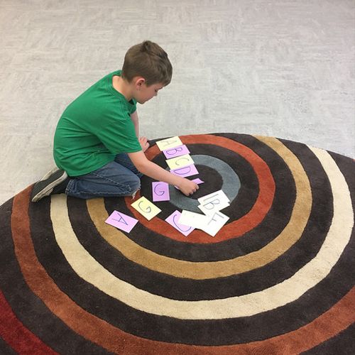A young student plays a musical game to reinforce 