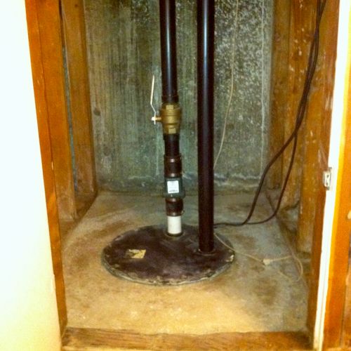 sump pump installed in a basement closet
