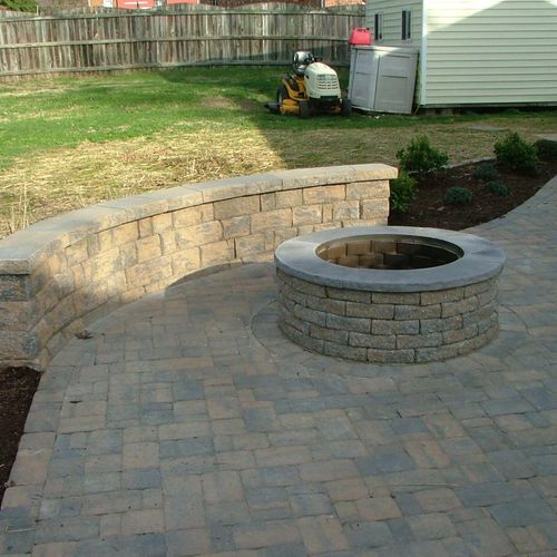 fire pit/patio with a sitting wall