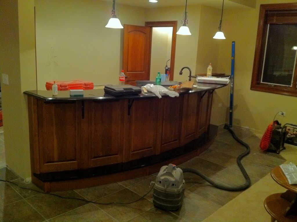 Custom bar with cherry raised panels & granite top
