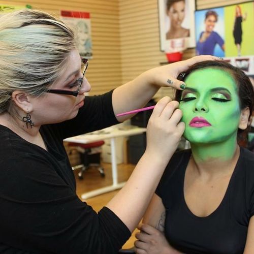 Action shot working on a green witch makeup 