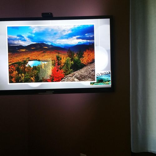 A 51" TV in a living room on an full motion/articu