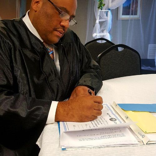 Hon. David Singleton signing marriage license