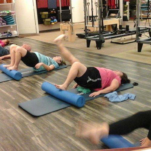 Clients hold stability movement on foam roller