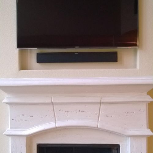 55" flat screen TV with 46" sound bar mounted over