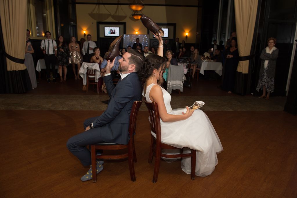 Bride and Groom Playing the Wedding Shoe Game