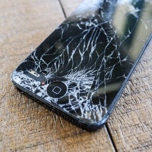 An iphone with a cracked screen