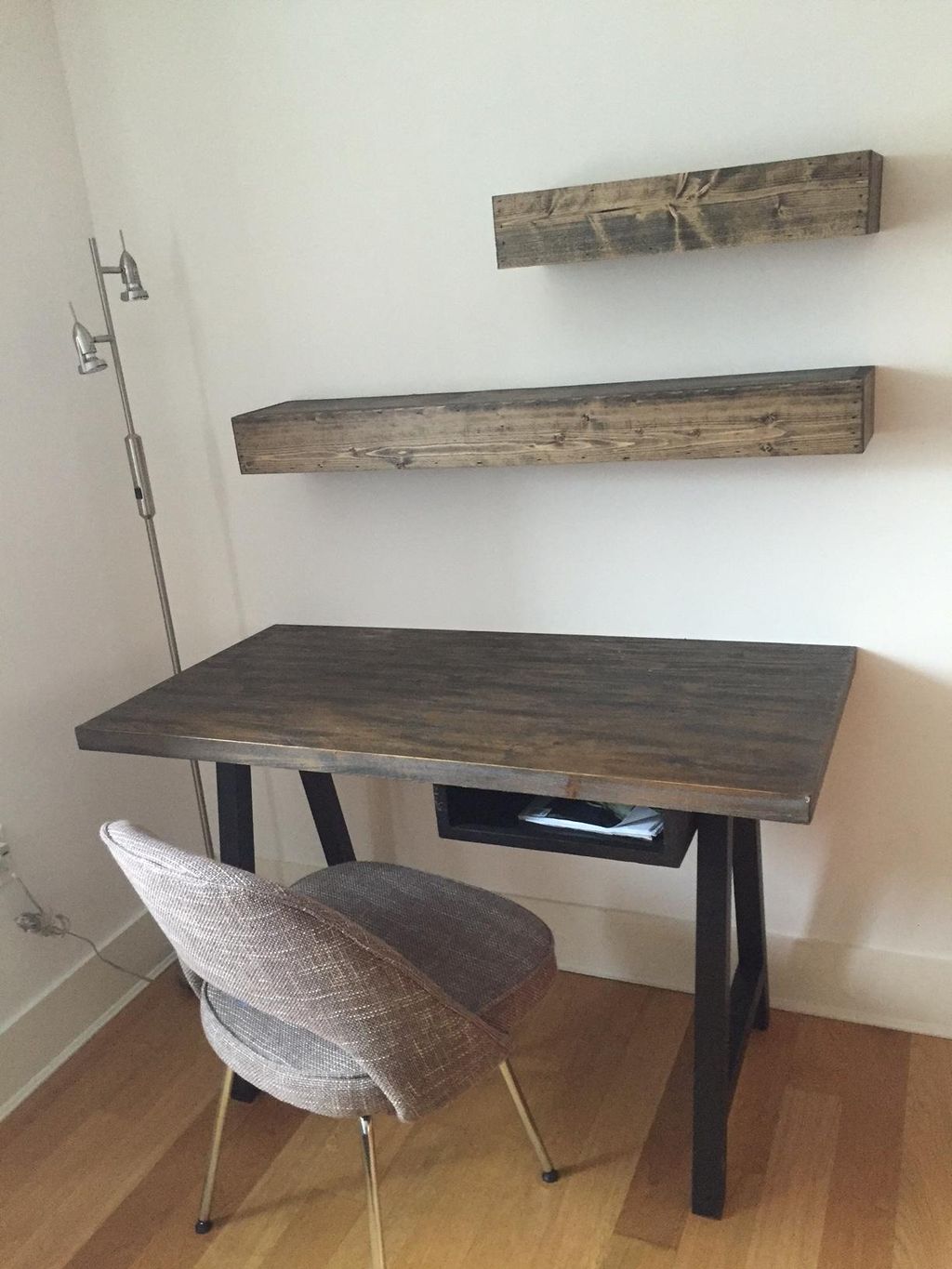 Installed floating shelves above clients desk
