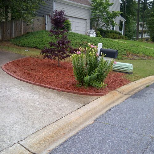 Planted trees and mulch and brick work.