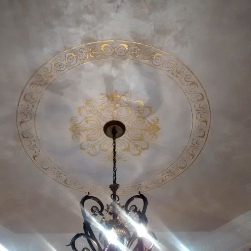 Plaster work with gold medallion. Crown molding pa