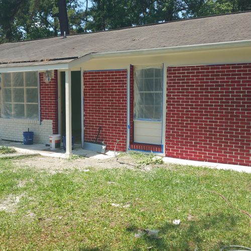 Painting the brick red on a house 1 by 1