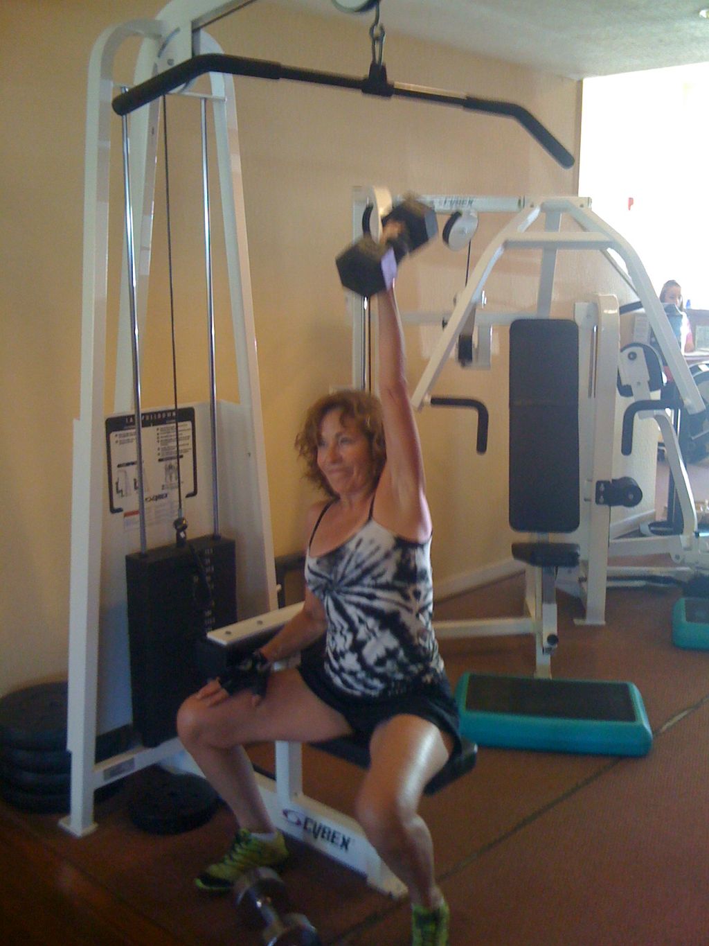 Barb doing one-armed seated overhead  presses at W