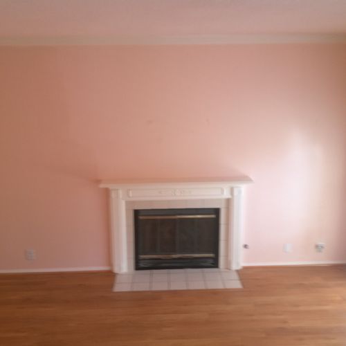 living room painted pink and fire place painted wh