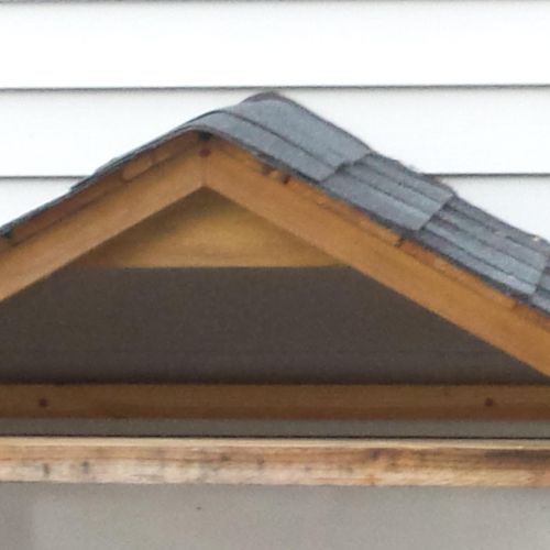 Roof overhang on exterior of garage door, to prote