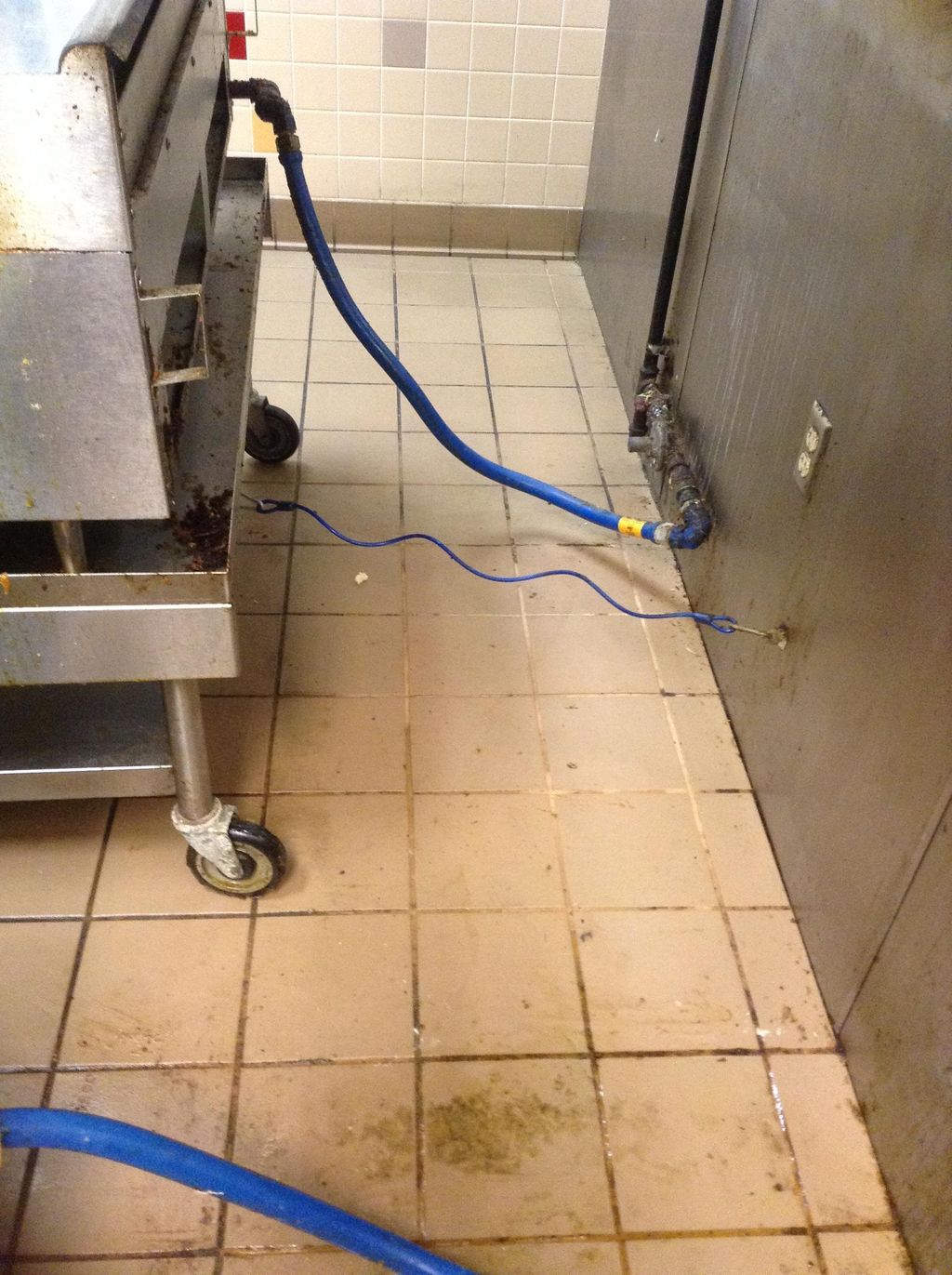 Commercial kitchen grease behind a fryer--"cleaned
