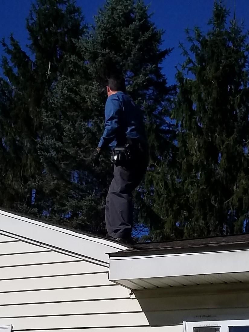 Huron Inspections, LLC performing roof inspection.