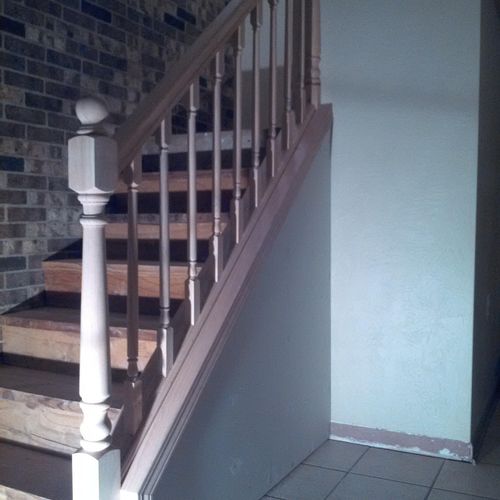 Built staircase, railing, and wall