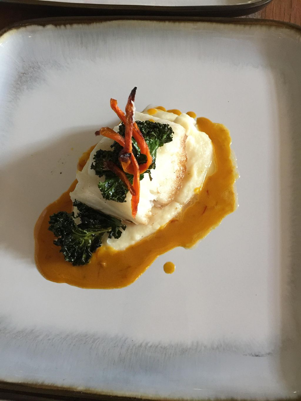 Sea Bass with Saffron Cream, Crispy Kale, and Pars