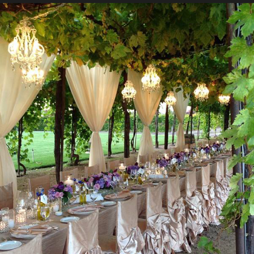 Small White Chandeliers hung over a tables and dra