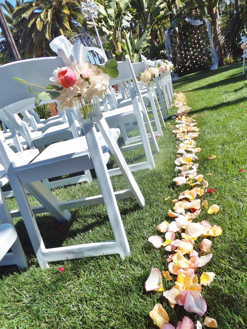 Rose petals down the aisle and jars filled with tu