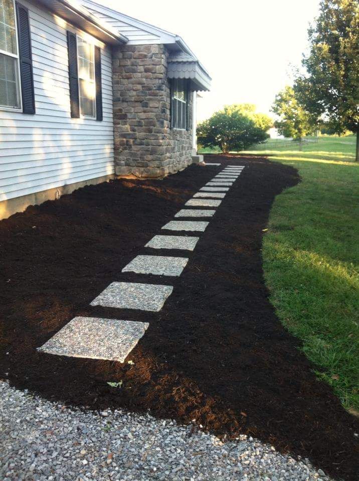 Mulch and stepping stones following concrete sidew