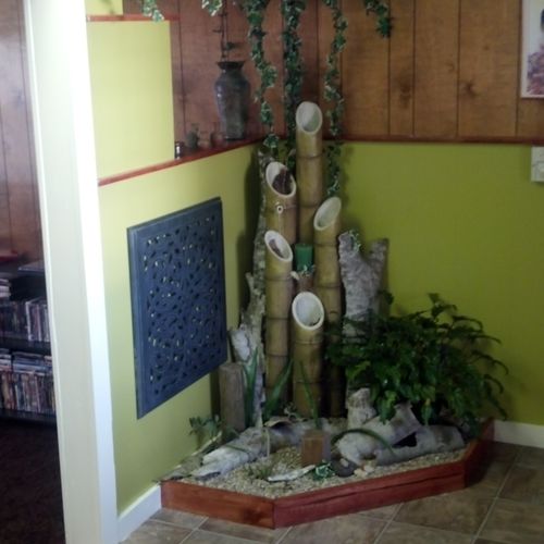 water feature with indoor planter. Green walls and