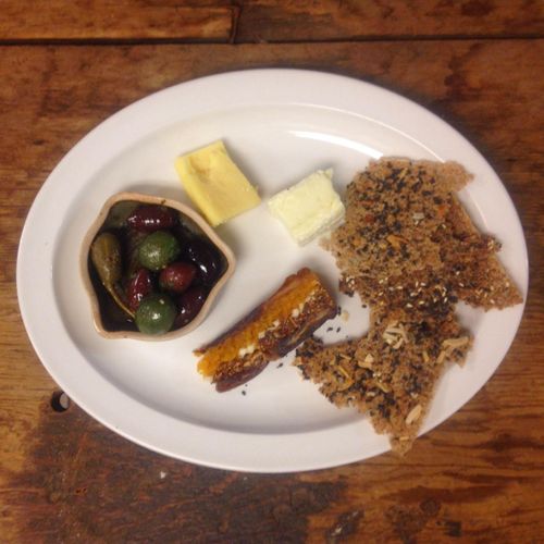 Cheese plate with warm marinated olives, panforte 