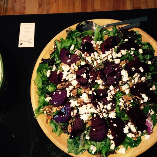 Mixed green salad with fresh beets, goat cheese an