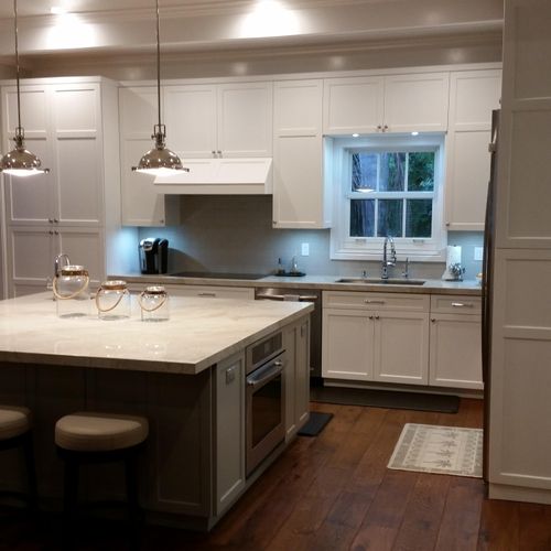 This kitchen features a large island and  a mix of