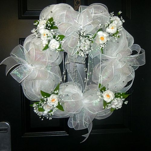 A stunning white mesh wreath accented with flowers