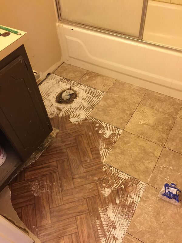 Bathroom floor - during (used a special adhesive t