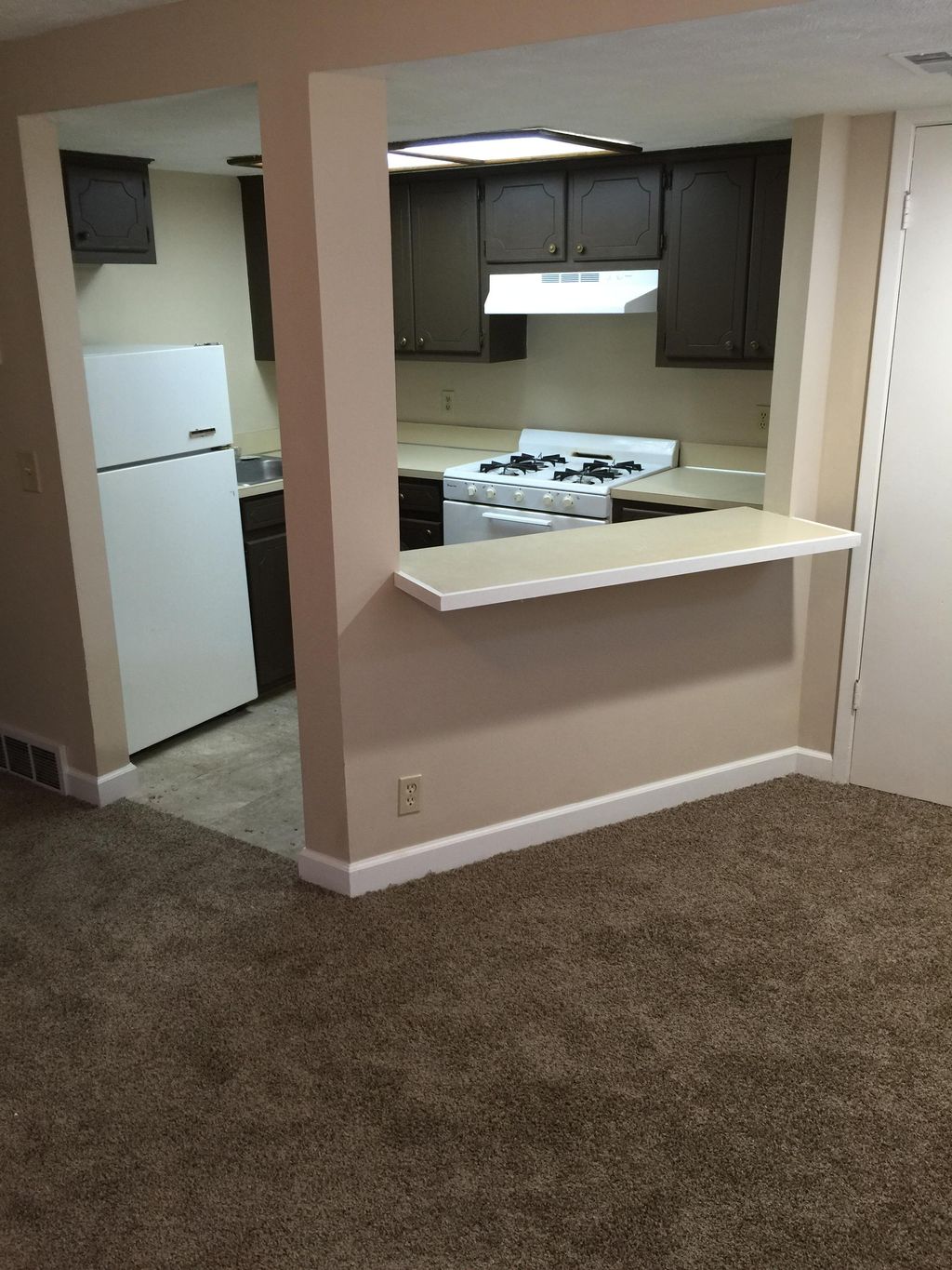 After: refinished cabinetry, repaired walls, islan