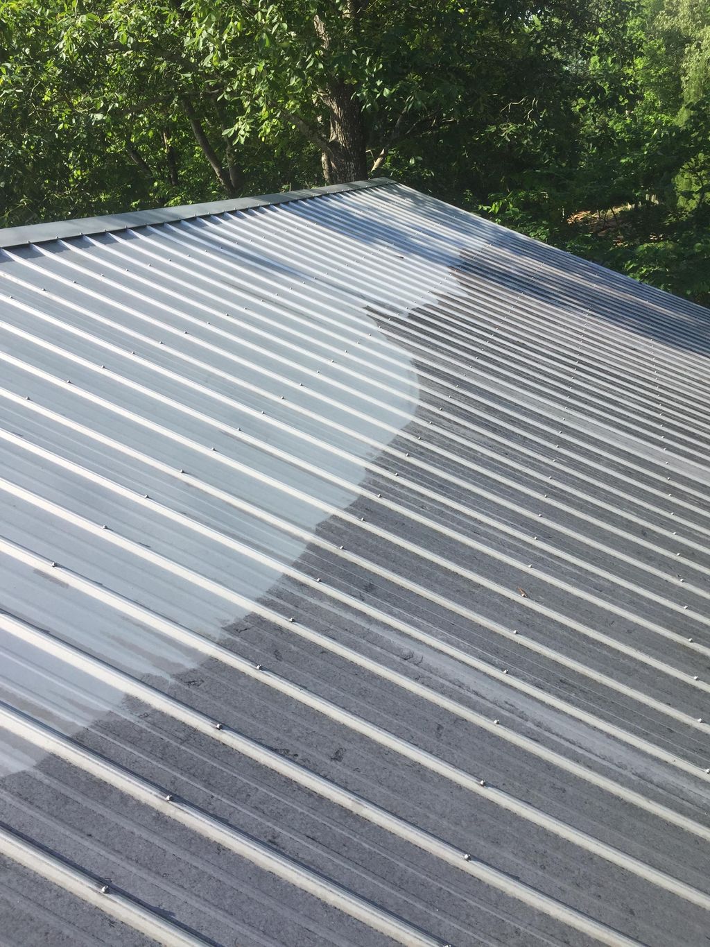 Pressure washing metal roof. 