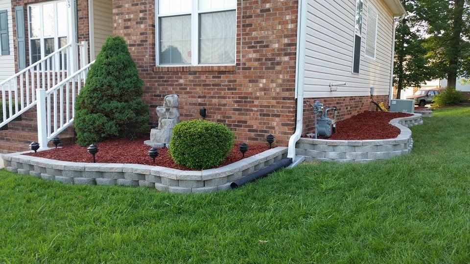 Here are some raised retaining wall flower beds wi