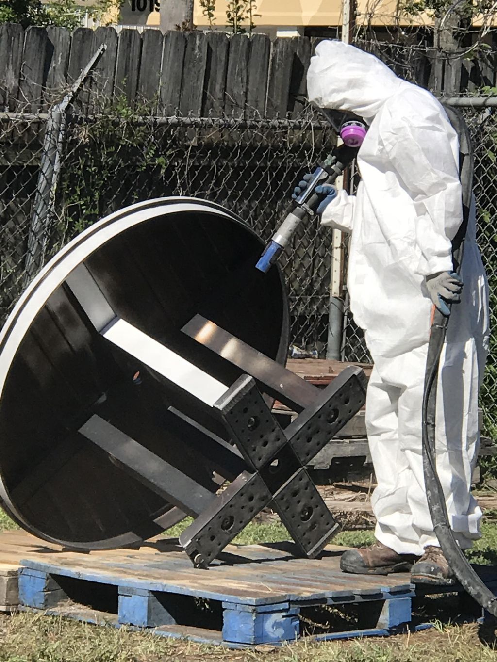 Blasting away the paint, revealing metal surface. 