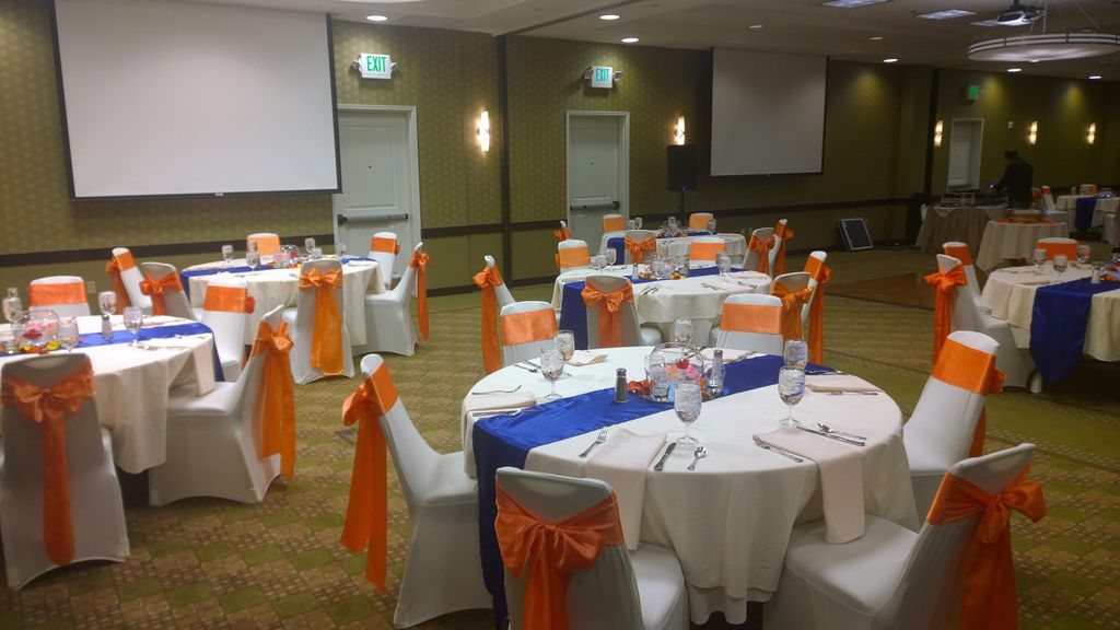 Wedding reception set up. Chair covers with silk b