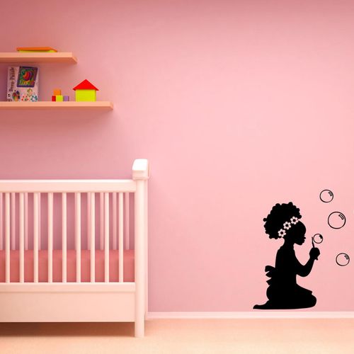 Wall decal of small afro child blowing bubbles.Get