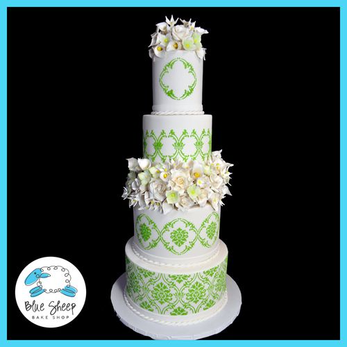 Four tiered wedding cake with celedon green lace a