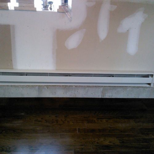 installed baseboard heater with electric from pane