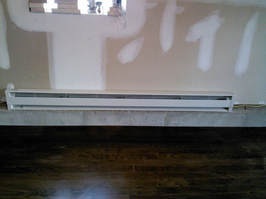 installed baseboard heater with electric from pane