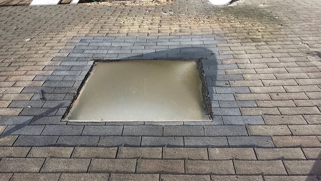 Leaking skylight repair. Removal of damaged shingl