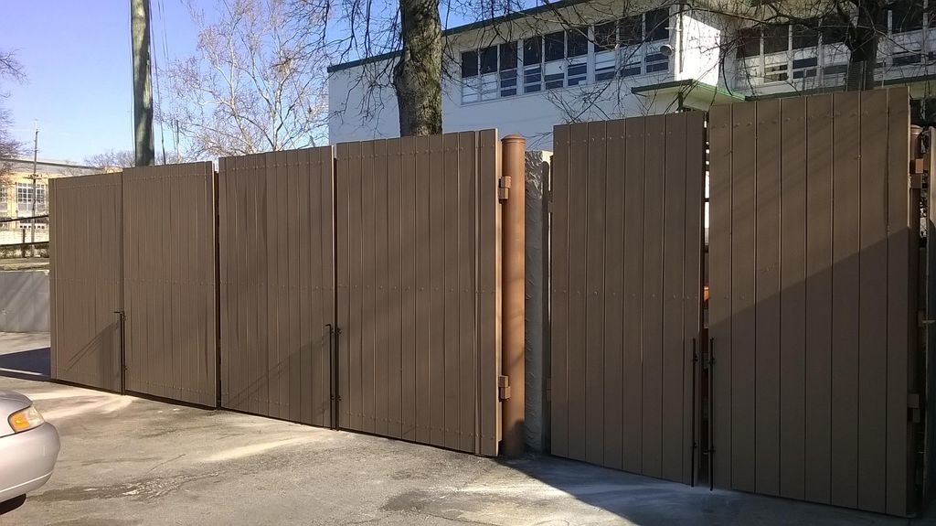 Dumpster gates with composite boards and heavy ste