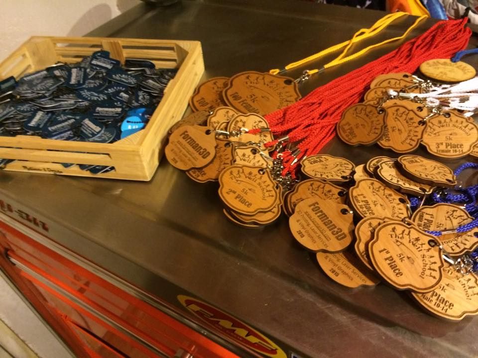 Custom laser cut awards for the Well School 5k