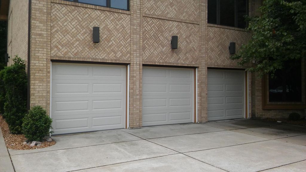 Three of four 8' x 7' doors installed by All Finis