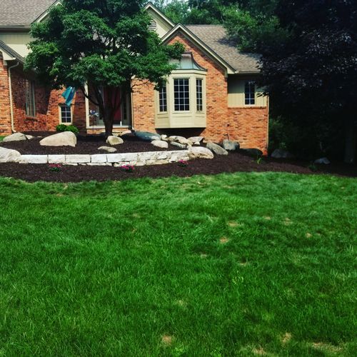  Built brick wall placed boulders and mulched