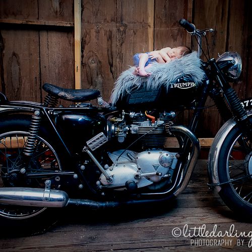Photo of a newborn baby on his mom's Triumph motor