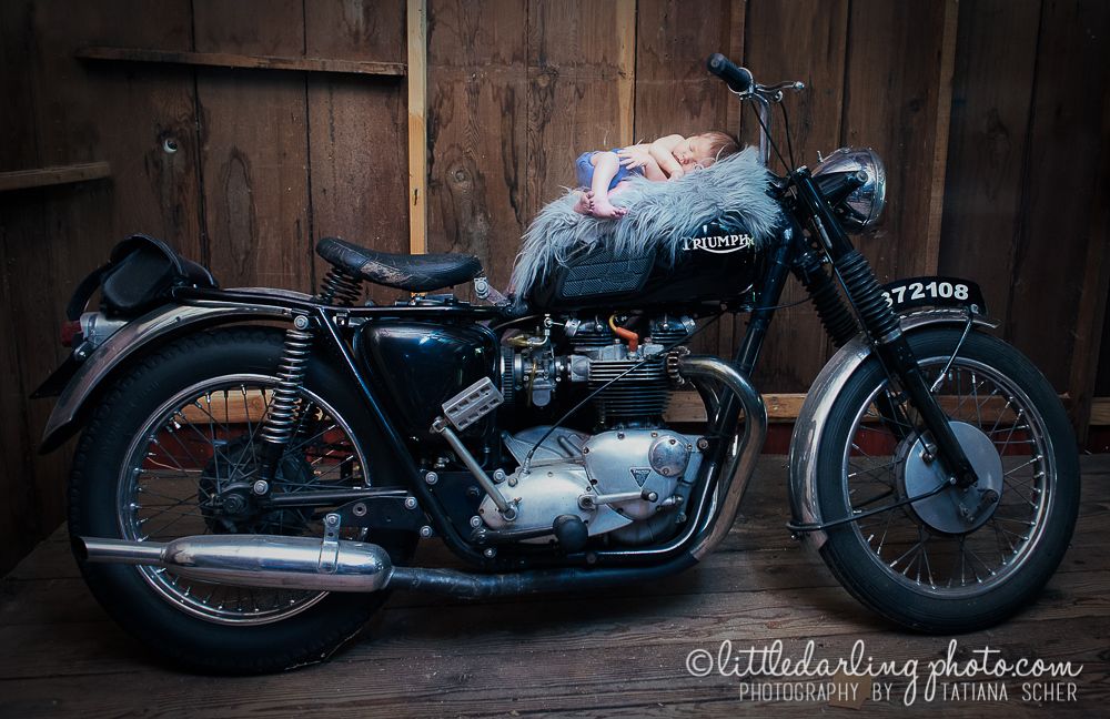 Photo of a newborn baby on his mom's Triumph motor