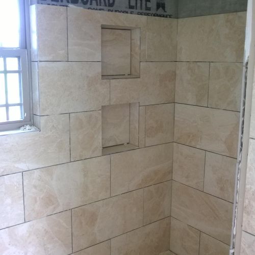 tiled shower with recessed shelving